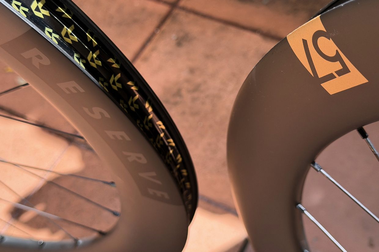 Reserve 57|64 Turbulent Aero deep section carbon wheelset with gold Reserve branding and 64mm rear rim profile